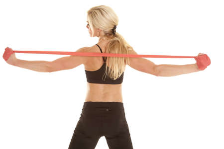 A woman stretching out her back and shoulders using her bandの写真素材