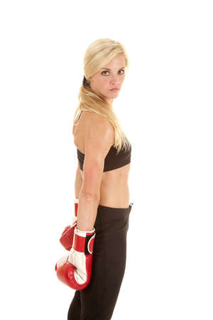 A woman standing with a serious expression on her face with her boxing gloves on.の写真素材
