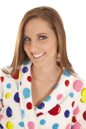 a close up of a woman in her polka dot robe with a smile on her face.の写真素材