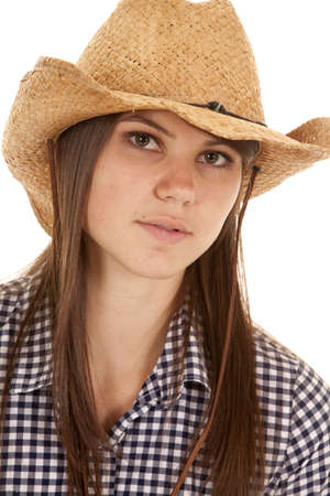A close up of woman with a small smile on her lips wearing her cowgirl hat.の写真素材