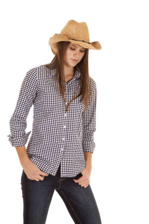 A cowgirl looking down wth a serious expression on her face.の写真素材