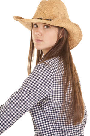 a woman sitting and looking over her shoulder with a serious expression on her lips.の写真素材