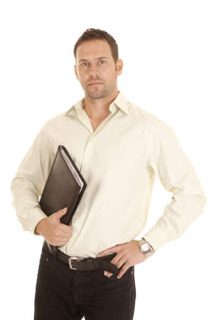 A man holding on to his binder with a serious expression on his face.の写真素材