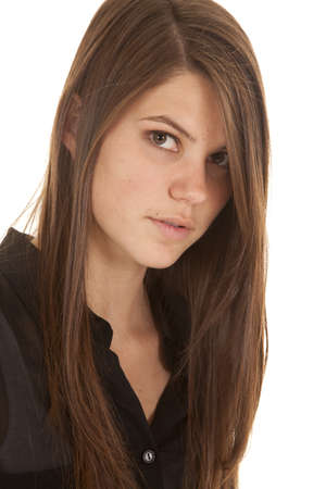 A close up of a woman's face in her black top with a serious expression on her face.の写真素材