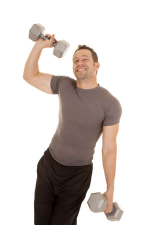 A man being a wimpy kind of guy not being able to lift big weights.の写真素材