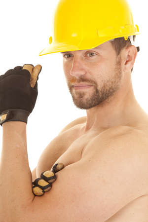 A man in his construction hat and gloves with out a shirt on and a smile on his face,の写真素材