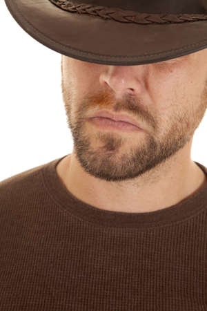 a close up of a cowboy's face with a serious expression on his face.の写真素材