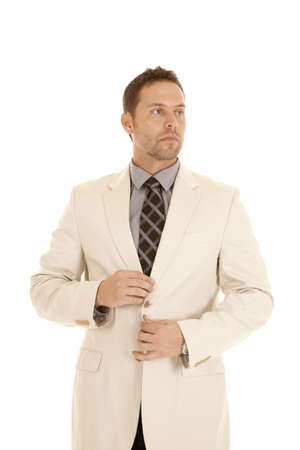 A business man fixing his suit coat with a serious expression.の写真素材