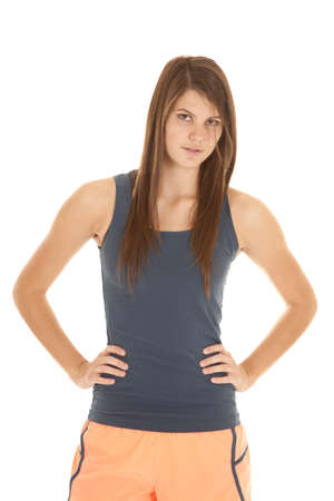 A woman with her hands on her hips in her workout clothing.の写真素材