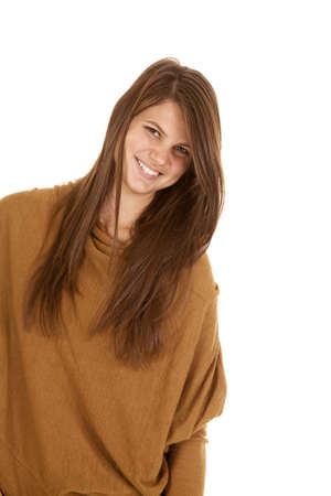 A woman leaning over and laughing in her brown sweater.の写真素材