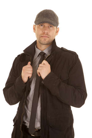 A man in his tie and coat wearing a hat with a serious expression on his face.の写真素材