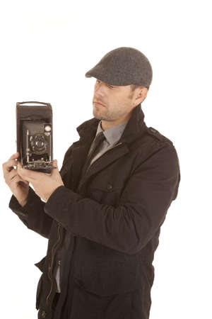 A man holding onto a  antique camera taking pictures.の写真素材