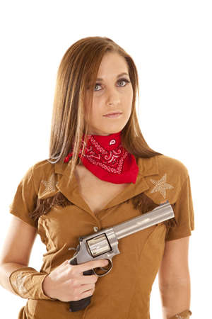 A woman in her western costume holding on to her gun.の写真素材