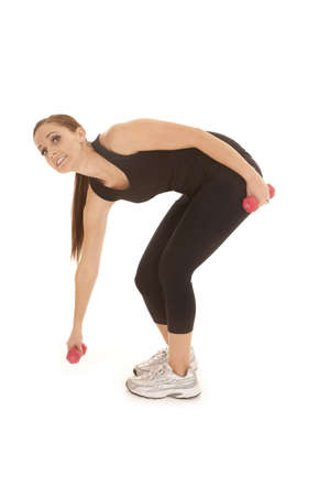 A woman having a hard time lifting up a little weight.の写真素材