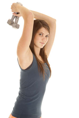 A woman looking while working out her tricepts with weights.の写真素材