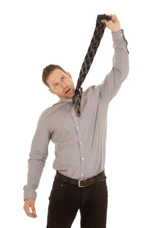 A man not having a good work day choking himself with his tie.の写真素材