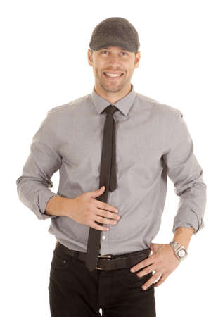 A man in his gray shirt and tie smiling while wearing a hat.の写真素材