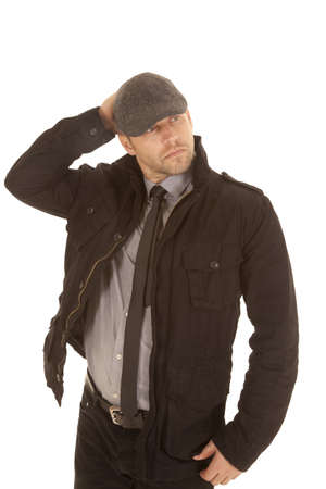 A man with his hand on his head with a serious expression thinking.の写真素材