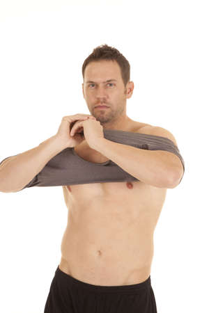 A man getting ready to put his shirt on after not having one onの写真素材