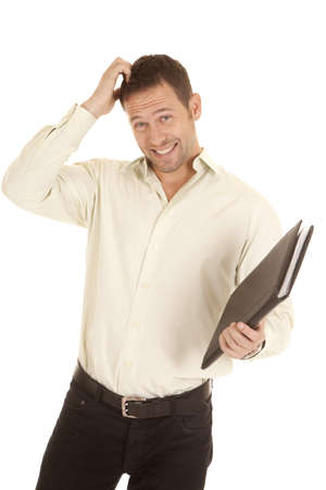 A man scratching his head with a confused expression on his face holding on to his binder.の写真素材