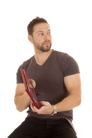 A man sitting on his stool showing someone his electronic tablet with a serious expression on his faceの写真素材