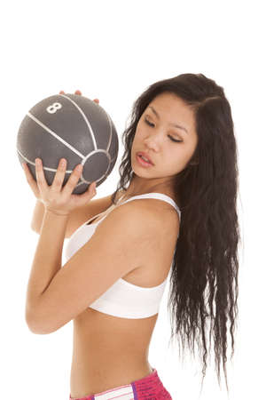 A woman working out with a weighted medicine ballの写真素材