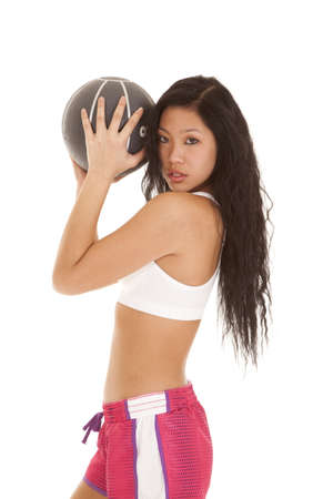 A woman working out with a weighted medicine ballの写真素材