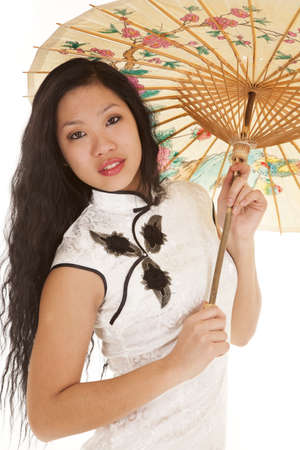An Asian woman in her traditional dress  and her umbrella in her handsの写真素材
