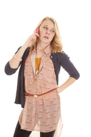 a woman showing how bored she is with the conversation on the phone.の写真素材