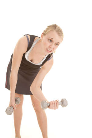 A woman having a hard time lifting her small weights.の写真素材
