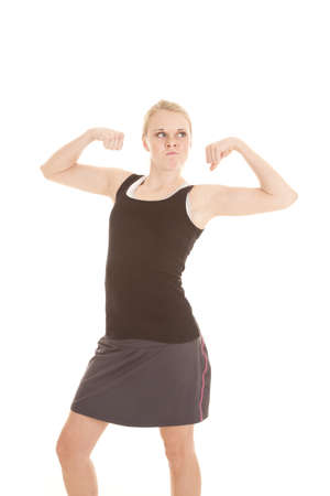 A woman showing off her muscles by flexing her arms.の写真素材