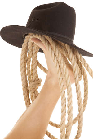 A woman has a cowboy hat and rope on her footの写真素材