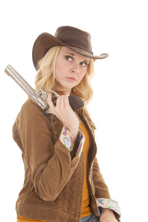 A woman with a serious expression on her face holding her gun on her shoulder.の写真素材