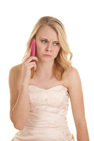 A woman with a mean and sad expression on her face while she is on her cell phone in her fancy dressの写真素材