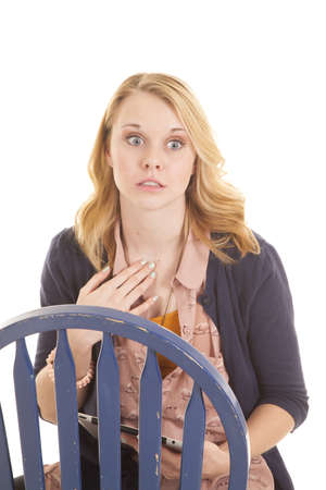 A woman with a shocked expression on her face holding on to her tablet.の写真素材
