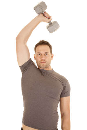 A man working out with a weight over his head working on his tricepts.の写真素材