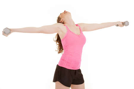 A woman is holding weights out and her head is tipped back.の写真素材