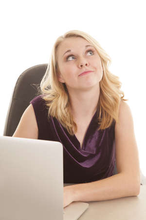 a woman working and looking up daydreaming .の写真素材