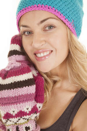 a close up of a woman's face in her hat and gloves with a smile on her face.の写真素材