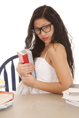 a woman holding on to her stack of books that she wants to keepの写真素材