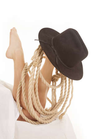 A woman with a rope and hat on her foot.の写真素材