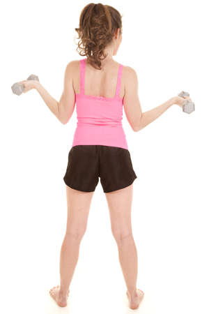 A woman with a pink tank top is holding weights.  View is from behind.の写真素材