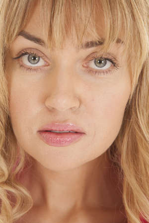 a close up of a woman's face with a serious expression on her faceの写真素材