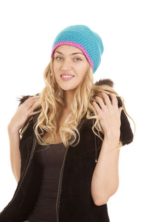 a woman in her furry hood coat and hat with a smile on her face.の写真素材