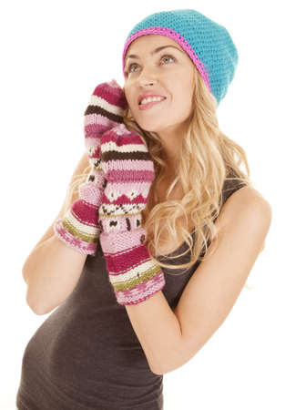 A woman with gloves and hat on with a smile on her faceの写真素材
