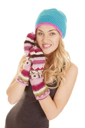 A woman with gloves and hat on with a smile on her faceの写真素材