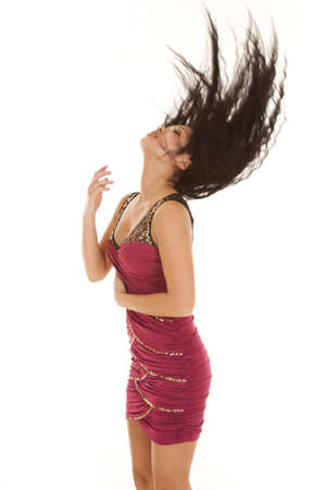 a woman flipping her hair back while wearing her formal dress.の写真素材