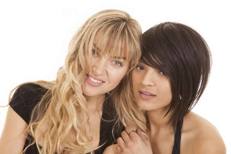 Two women with their heads together showing off their friendship.の写真素材