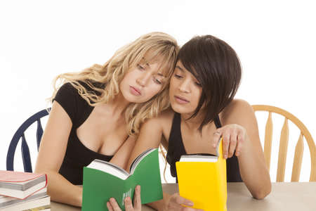 two women really getting into their books and getting tired of studying.の写真素材