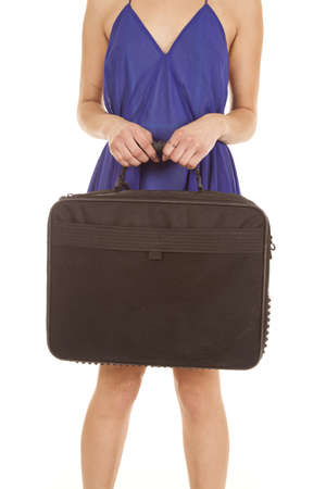 A woman holding onto her briefcase ready to go to workの写真素材